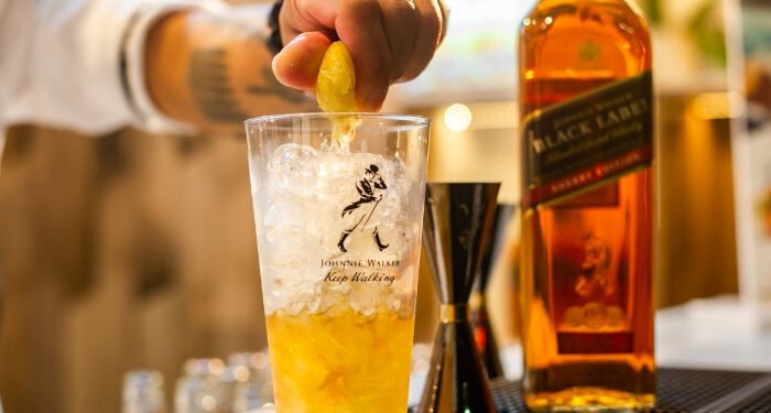 How Has Johnnie Walker Successfully Positioned Itself as a Global Icon in the World of Whisky?
